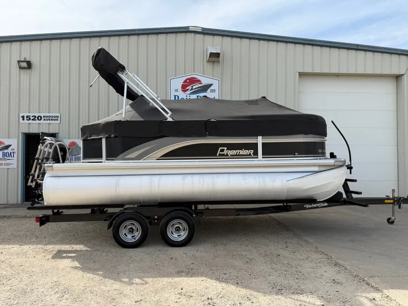 Slide: The Image of 2012 Premier 180 SunSation pontoon boat on trailer, parked outside a building. - 23