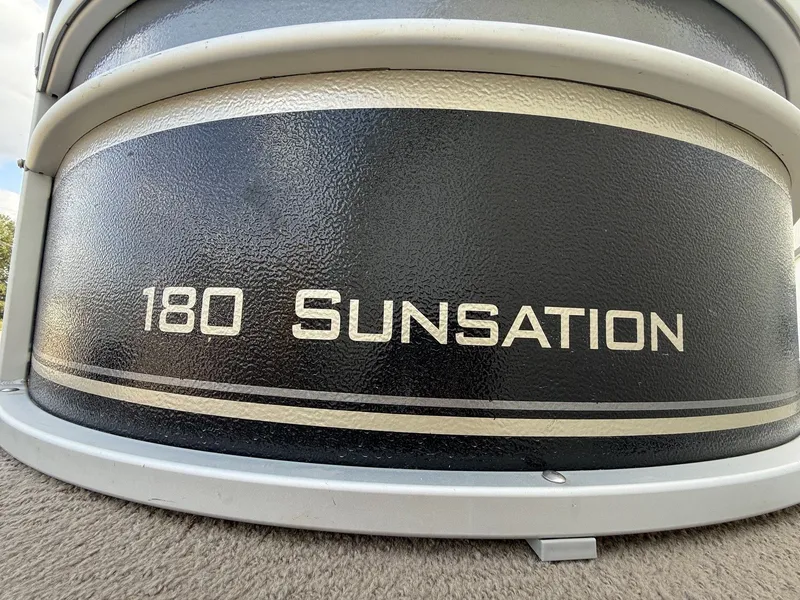 Slide: The Image of 2012 Premier 180 SunSation boat logo on black textured surface. - 4
