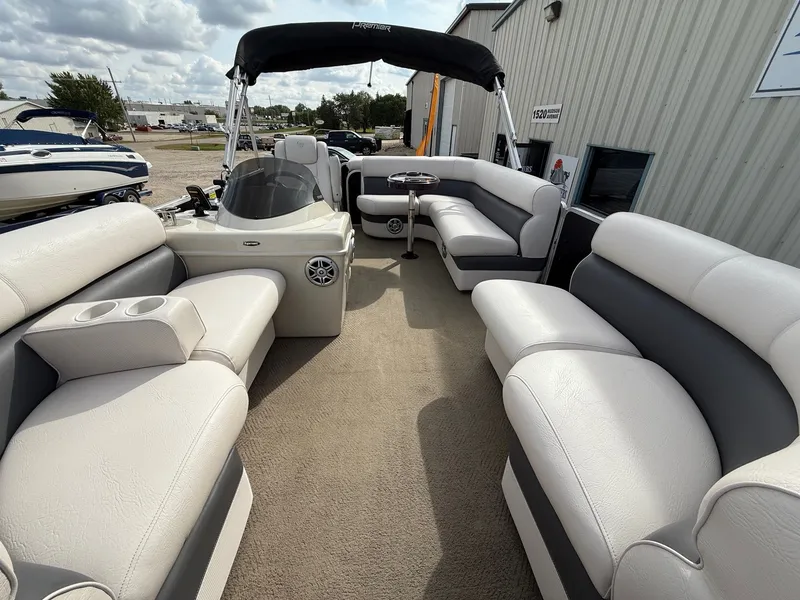 Slide: The Image of 2012 Premier 180 SunSation pontoon boat with spacious seating and canopy, docked outdoors. - 5