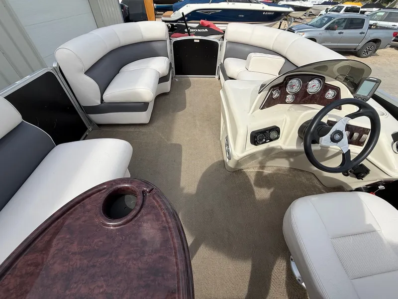 Slide: The Image of Interior of 2012 Premier 180 SunSation pontoon boat with plush seating and steering console. - 8