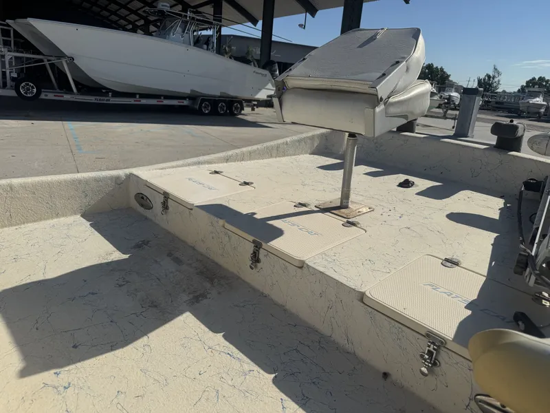 Slide: The Image of 2005 Flats Cat 21 boat interior with seating and storage compartments. - 12
