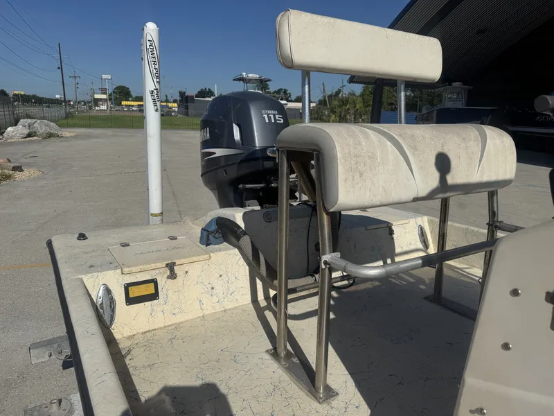 Slide: The Image of 2005 Flats Cat 21 boat with Yamaha 115 outboard motor in a parking area. - 13