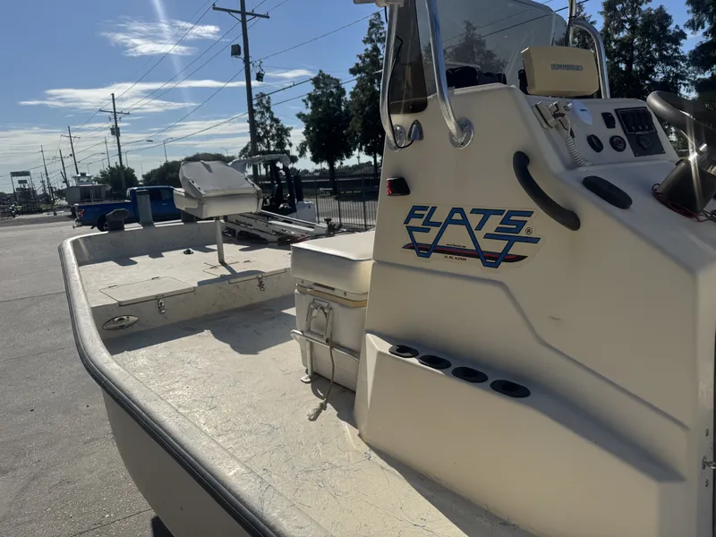Slide: The Image of 2005 Flats Cat 21 boat parked outdoors, showcasing console and seating area. - 15