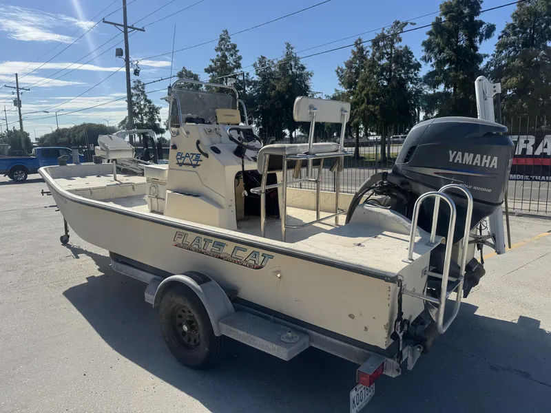 Slide: The Image of 2005 Flats Cat 21 boat with Yamaha outboard motor on trailer, parked outdoors. - 3