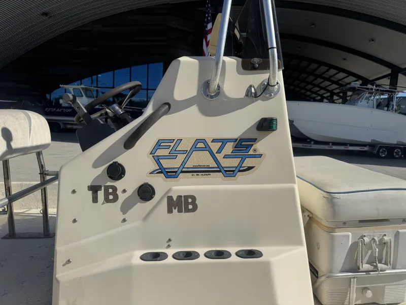 Slide: The Image of Console of a 2005 Flats Cat 21 boat with logo and controls. - 5