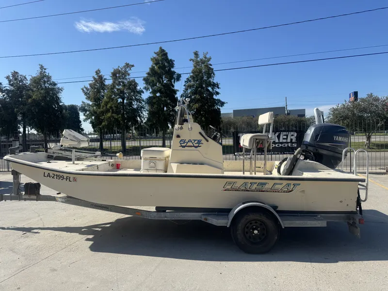 Slide: The Image of 2005 Flats Cat 21 boat on trailer with Yamaha outboard motor, parked outdoors. - 8