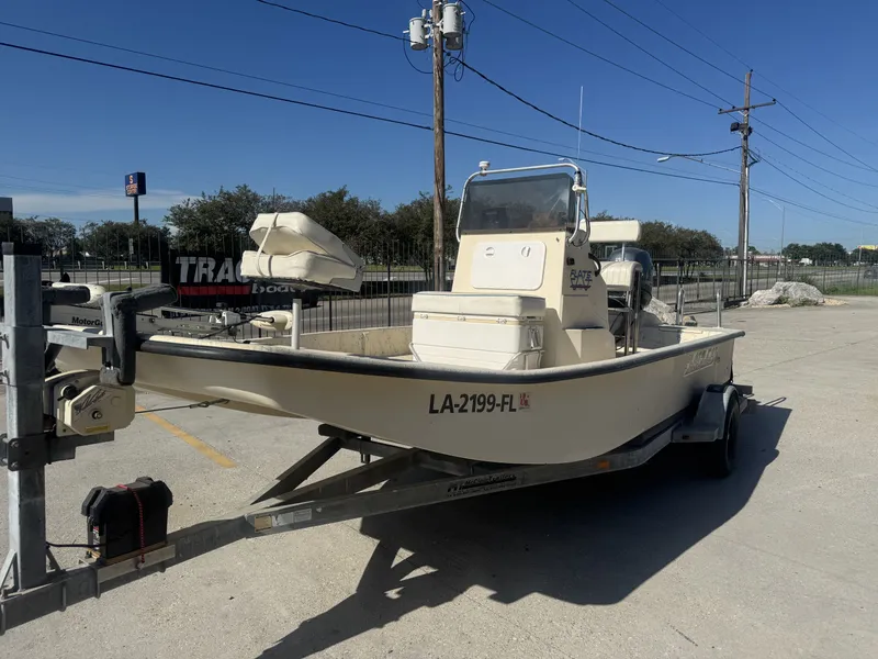 Slide: The Image of 2005 Flats Cat 21 boat on trailer in parking lot, sunny day. - 9