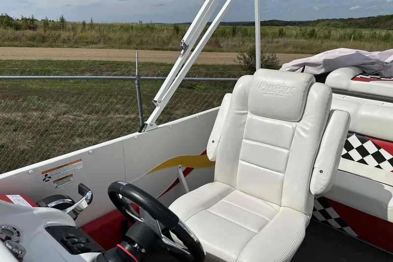 Slide: The Image of 2017 PlayCraft 2700 Extreme boat interior with white leather seating and steering wheel. - 21