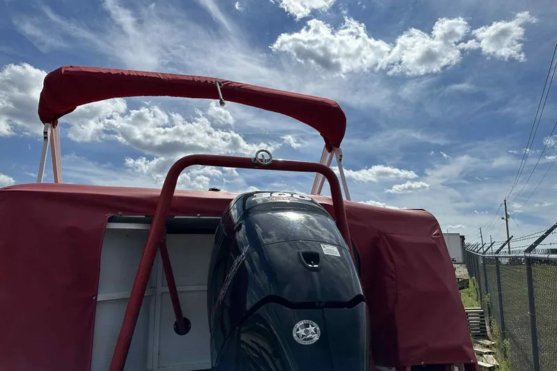 Slide: The Image of 2017 PlayCraft 2700 Extreme boat with red canopy and powerful outboard motor. - 23