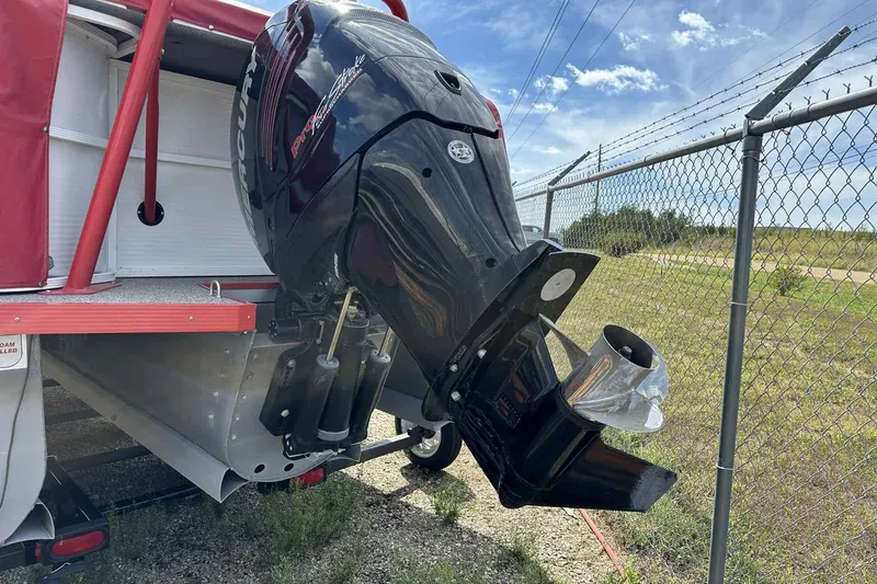 Slide: The Image of 2017 PlayCraft 2700 Extreme boat with Mercury outboard motor near chain-link fence. - 25