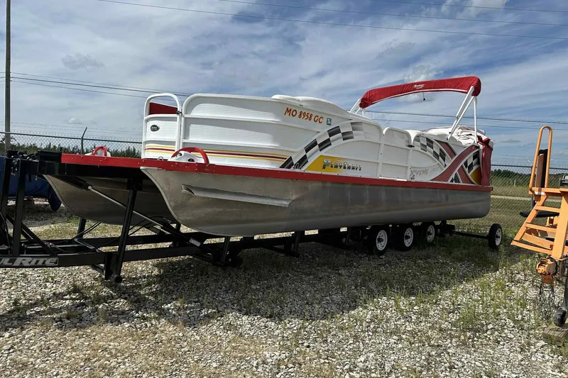 Slide: The Image of 2017 PlayCraft 2700 Extreme pontoon boat on trailer, parked outdoors. - 28