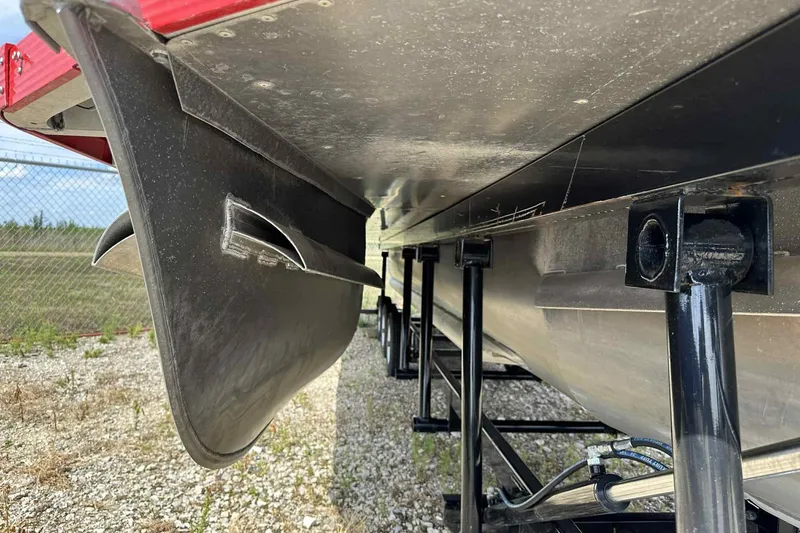 Slide: The Image of Underneath view of a 2017 PlayCraft 2700 Extreme pontoon boat on a trailer. - 30