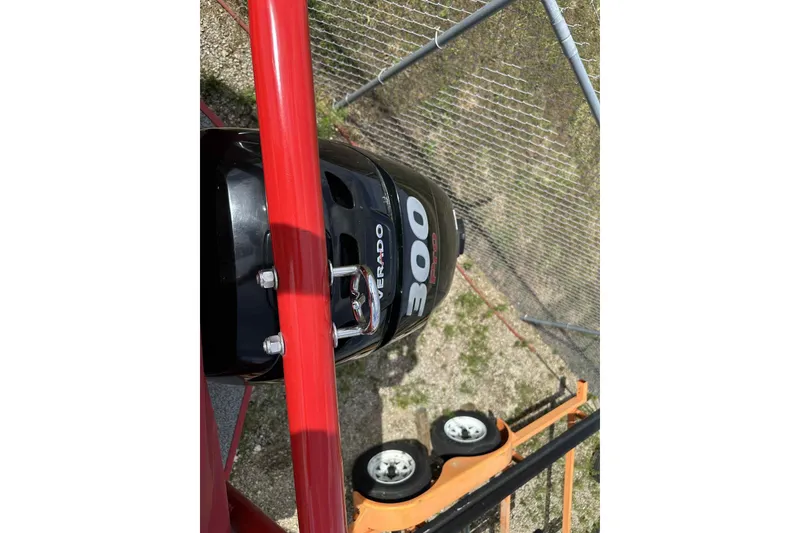 Slide: The Image of 2017 PlayCraft 2700 Extreme with Verado 300 engine, viewed from above near a fence. - 31