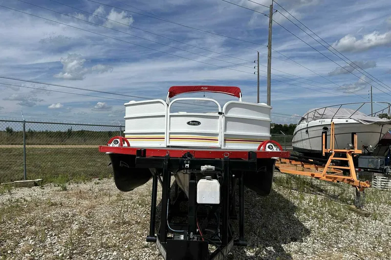 Slide: The Image of 2017 PlayCraft 2700 Extreme pontoon boat on trailer, parked outdoors under a blue sky. - 35