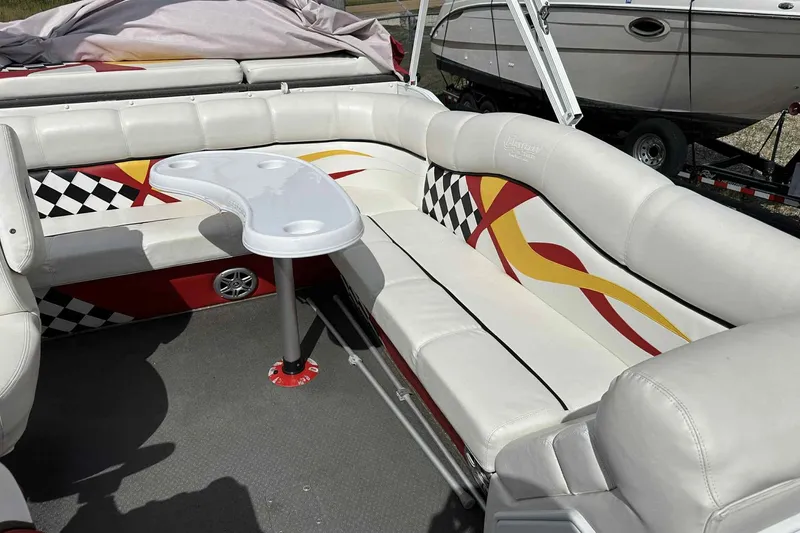 Slide: The Image of 2017 PlayCraft 2700 Extreme boat interior with white seating and colorful checkered design. - 9