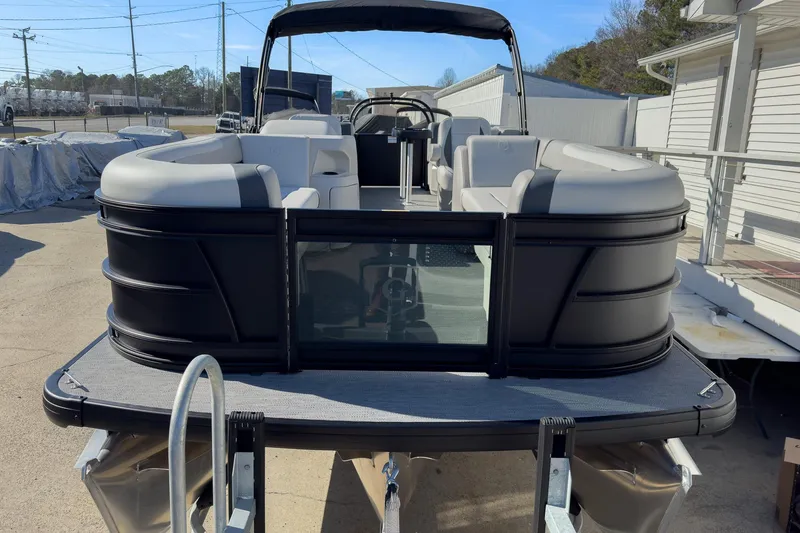 Slide: The Image of 2026 Godfrey Sweetwater 22' Split Bench Tritoon, sleek design, spacious seating, outdoor setting. - 18