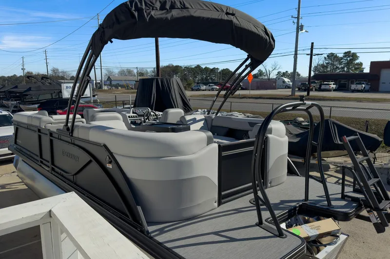 Slide: The Image of 2026 Godfrey Sweetwater 22' Split Bench Tritoon with canopy, parked outdoors. - 23