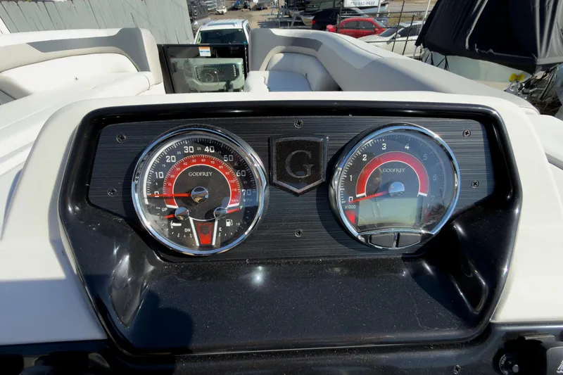 Slide: The Image of Dashboard of 2026 Godfrey Sweetwater 22' Split Bench Tritoon, featuring speedometer and tachometer. - 39