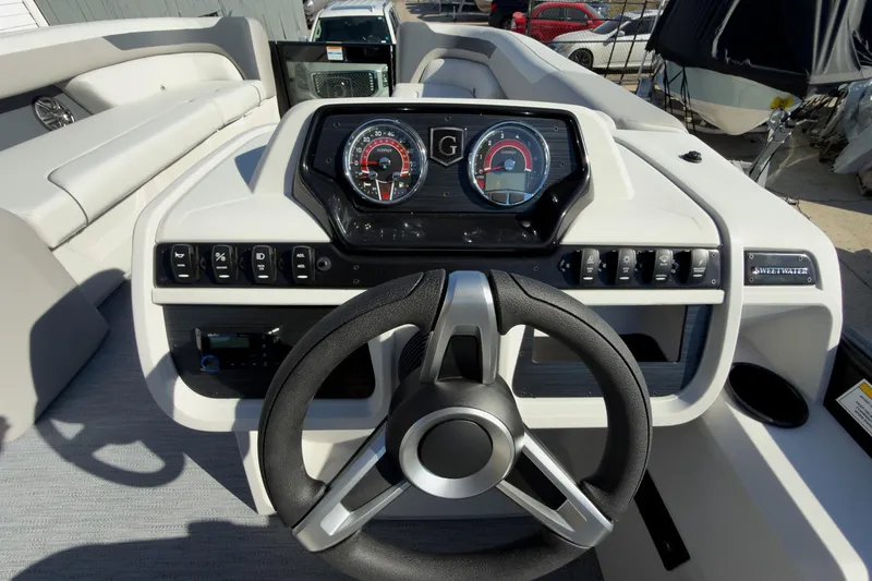 Slide: The Image of Steering console of 2026 Godfrey Sweetwater 22' Split Bench Tritoon boat, featuring modern controls. - 40