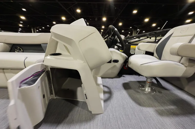 Slide: The Image of 2026 Godfrey Sweetwater 22' Tritoon interior with open storage and captain's chair. - 7