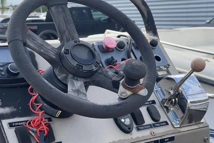 Slide: The Image of Steering console of 2016 Pro-Drive X Series 20' boat with controls and steering wheel. - 4