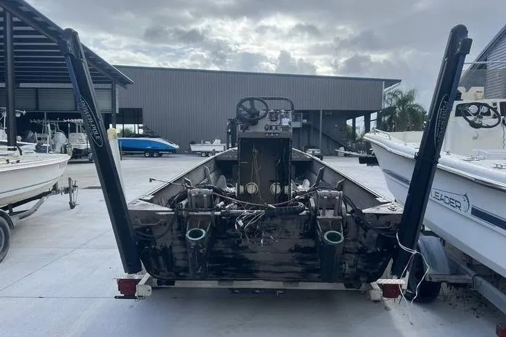 Slide: The Image of 2016 Pro-Drive X Series 20' boat in a marina, rear view with overcast sky. - 7