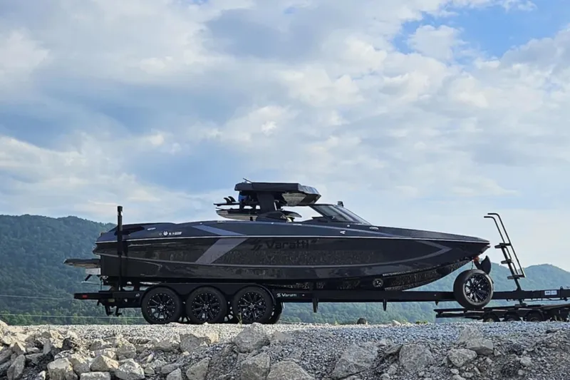 Slide: The Image of 2025 Varatti Z2474 boat on trailer, scenic mountain backdrop, cloudy sky. - 14