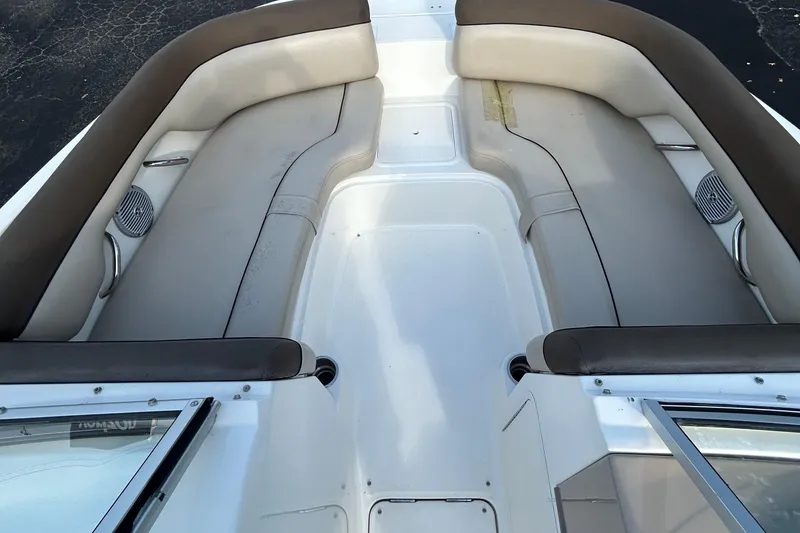 Slide: The Image of Interior view of a 2015 Bayliner 215 boat with cushioned seating. - 10