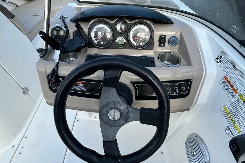 Slide: The Image of Steering console of a 2015 Bayliner 215 boat with gauges and controls. - 7