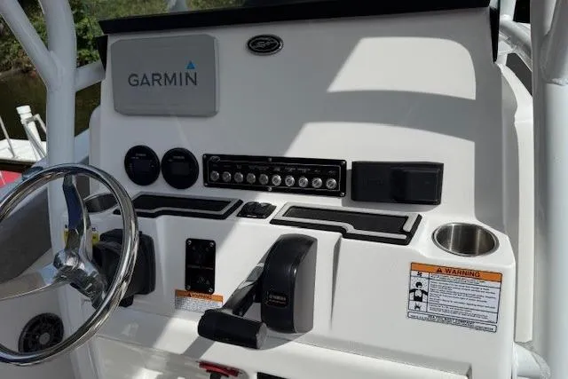 Slide: The Image of 2024 Sea Fox 228 Commander dashboard with Garmin navigation system and control panel. - 24