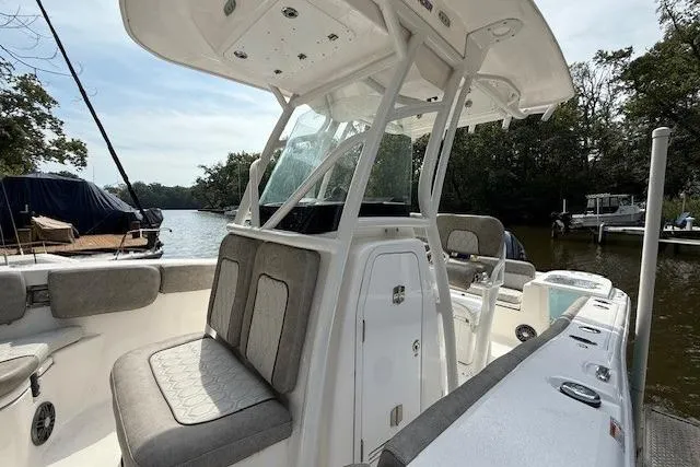 Slide: The Image of 2024 Sea Fox 228 Commander boat displayed on stands, blue hull, outdoor setting. - 3