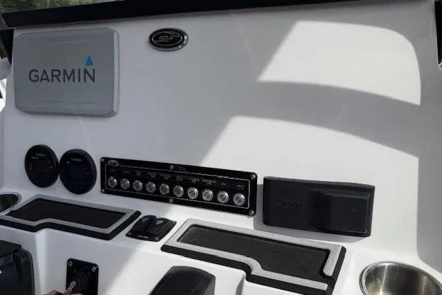 Slide: The Image of 2024 Sea Fox 228 Commander boat docked on a sunny day, side view. - 6