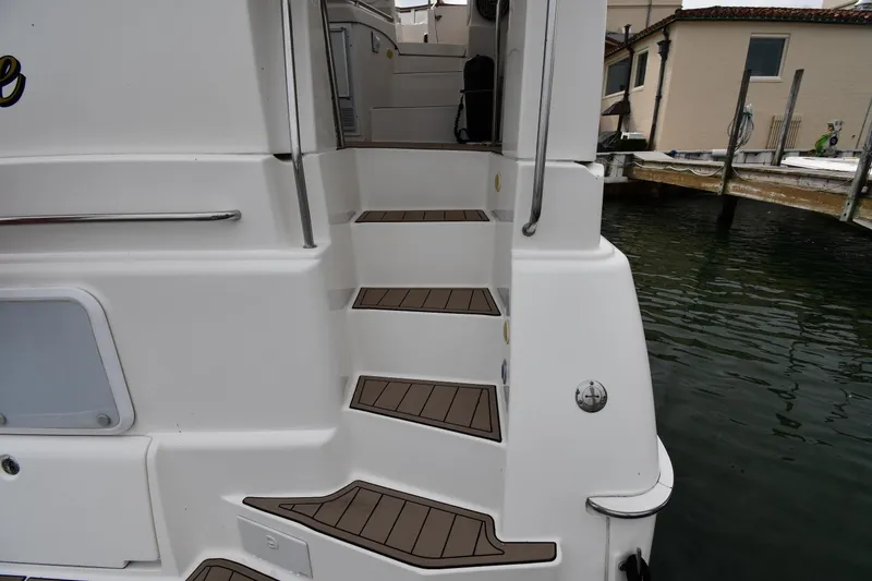 Slide: The Image of Staircase on a 2000 Silverton 392 Motor Yacht by the water. - 10