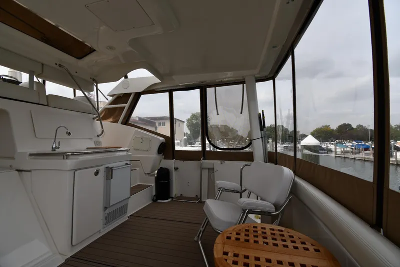Slide: The Image of Interior of 2000 Silverton 392 Motor Yacht with kitchenette and seating area. - 11