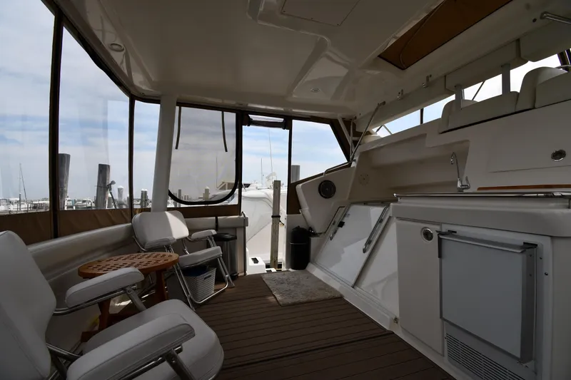 Slide: The Image of 2000 Silverton 392 Motor Yacht interior with seating, table, and kitchenette. - 12