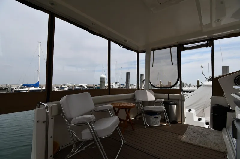 Slide: The Image of Interior view of 2000 Silverton 392 Motor Yacht with marina backdrop. - 13