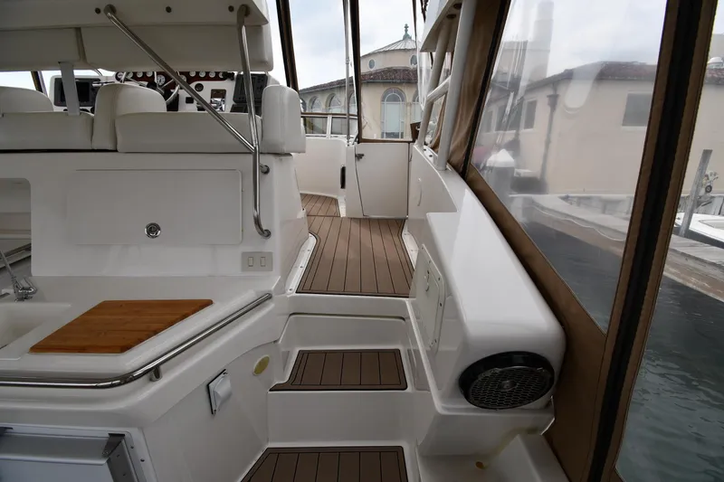 Slide: The Image of 2000 Silverton 392 Motor Yacht interior with sleek seating and wood accents. - 14