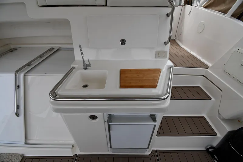 Slide: The Image of 2000 Silverton 392 Motor Yacht interior with sink, cutting board, and steps. - 24