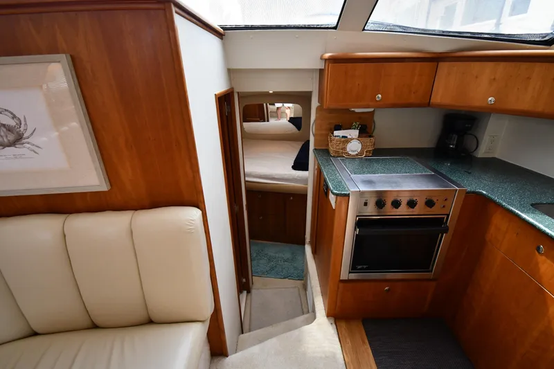 Slide: The Image of Interior of 2000 Silverton 392 Motor Yacht with kitchen and cozy cabin view. - 27