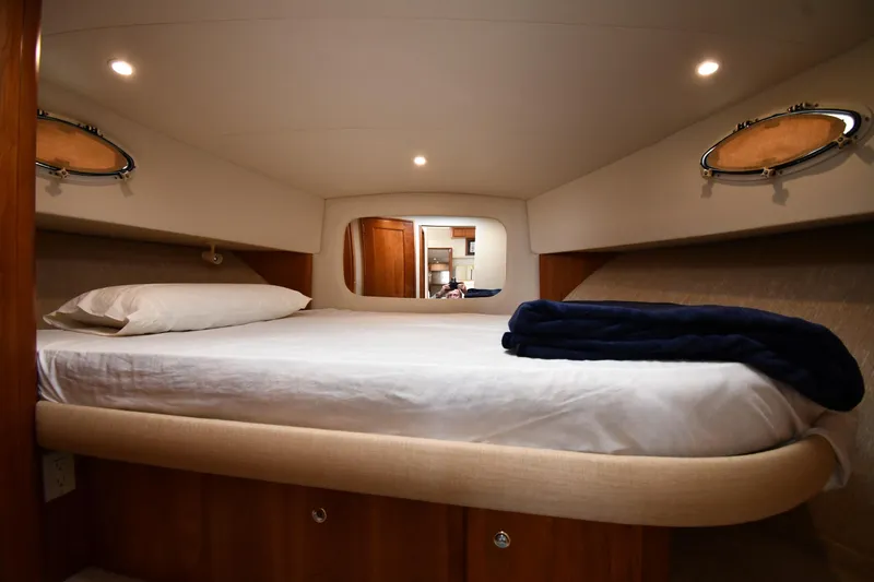 Slide: The Image of Cozy bedroom in 2000 Silverton 392 Motor Yacht with portholes and soft lighting. - 28