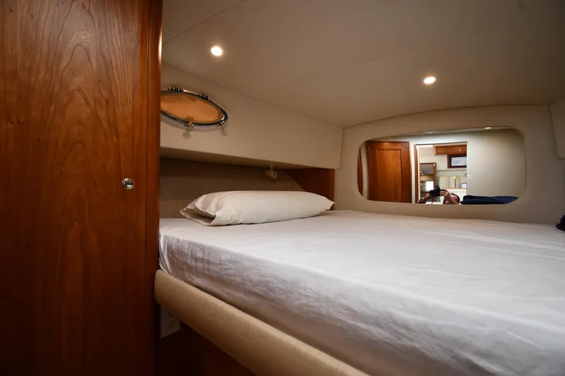 Slide: The Image of Interior cabin of 2000 Silverton 392 Motor Yacht with bed and wooden accents. - 30