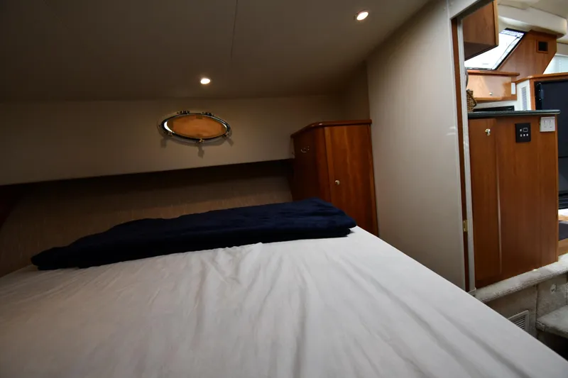 Slide: The Image of Interior cabin of 2000 Silverton 392 Motor Yacht with bed and wooden cabinetry. - 32