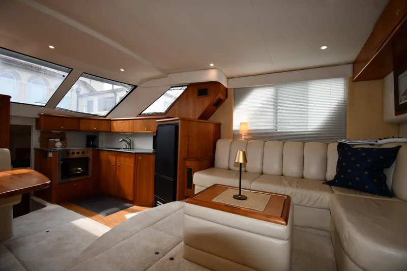 Slide: The Image of Luxurious interior of 2000 Silverton 392 Motor Yacht with modern kitchen and cozy seating area. - 36