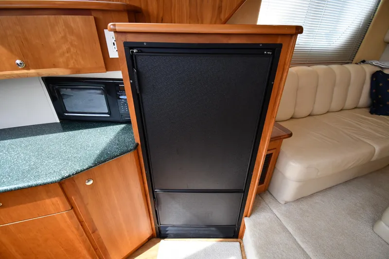 Slide: The Image of Interior of 2000 Silverton 392 Motor Yacht with kitchenette and seating area. - 43