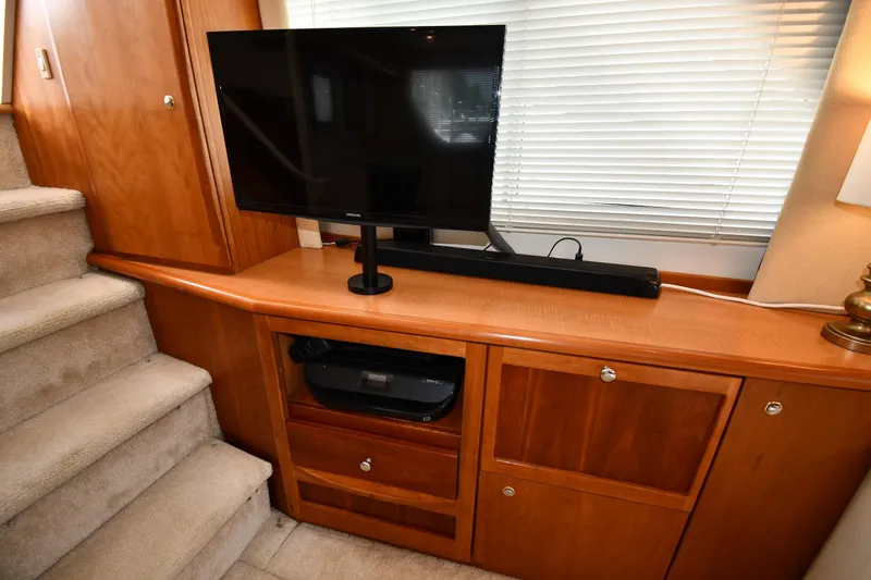 Slide: The Image of Interior of 2000 Silverton 392 Motor Yacht with TV and wooden cabinetry. - 45