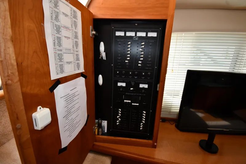 Slide: The Image of Electrical panel inside 2000 Silverton 392 Motor Yacht with control switches and monitor. - 46