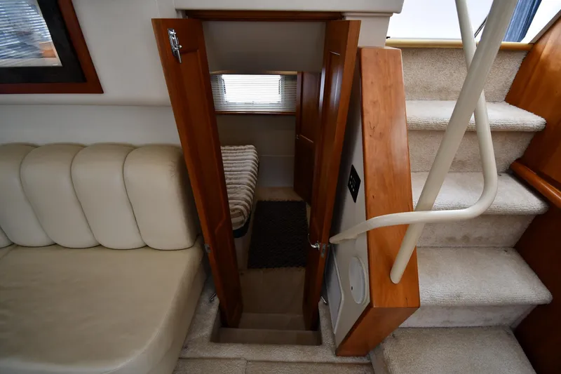 Slide: The Image of Interior of 2000 Silverton 392 Motor Yacht with stairs and cozy seating area. - 47