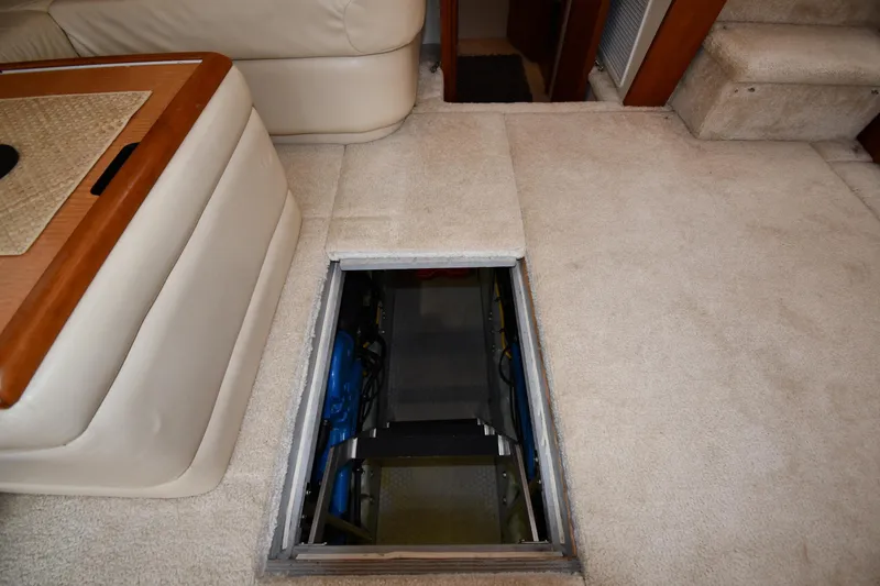 Slide: The Image of Carpeted interior of 2000 Silverton 392 Motor Yacht with open engine access hatch. - 54
