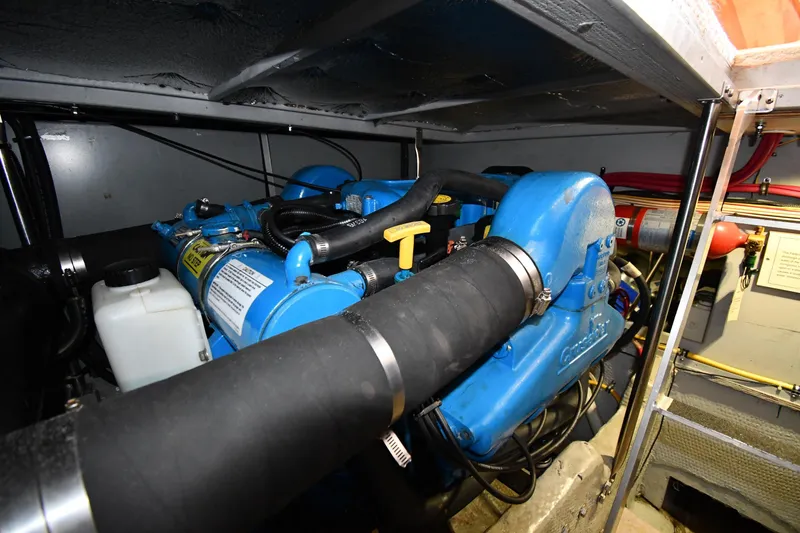 Slide: The Image of Engine room of 2000 Silverton 392 Motor Yacht with blue machinery components. - 55