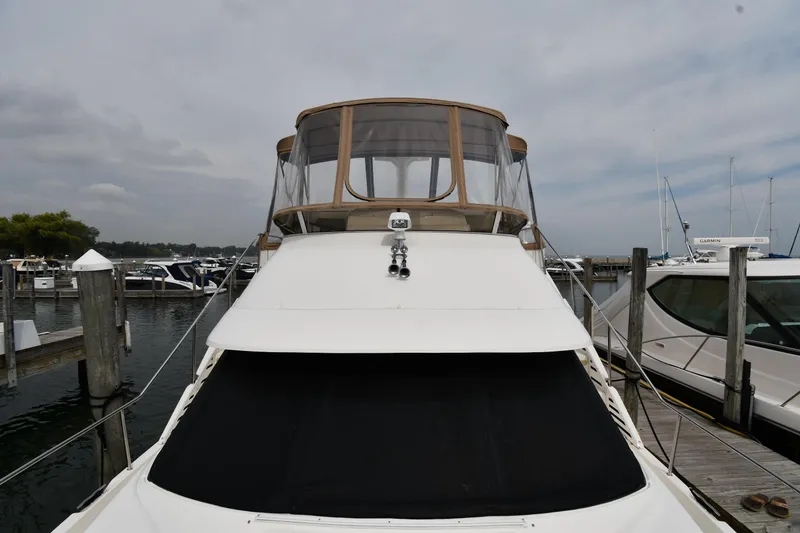 Slide: The Image of 2000 Silverton 392 Motor Yacht docked at marina, front view. - 6